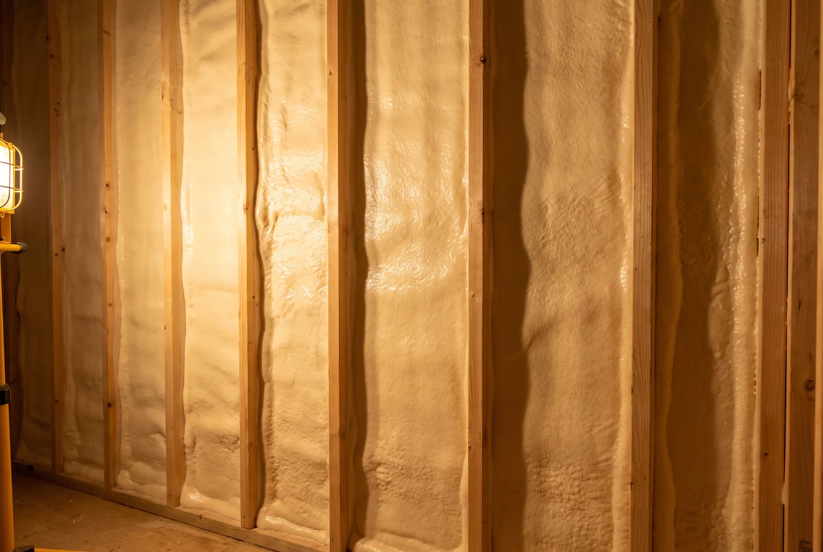 Closed-cell spray foam filling the cavities between wall studs
